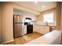 Well-lit kitchen featuring stainless steel appliances and white cabinets at 724 Redland Dr, Jonesboro, GA 30238