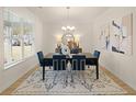 Bright dining room features a large table with blue velvet chairs and an eye-catching rug at 799 River Gardens Se Dr, Atlanta, GA 30354