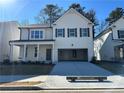 Two-story house with white siding, gray shutters, and a two-car garage at 799 River Gardens Se Dr, Atlanta, GA 30354