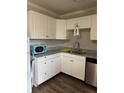 White cabinets, granite countertops, and a corner sink in this kitchen at 809 Jordan Ln # K3, Decatur, GA 30033