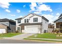 Two-story house with white siding, gray shutters, and a two-car garage at 4839 Dufour Dr, Lilburn, GA 30047