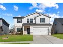 Two-story house with white siding, gray shutters, and a two-car garage at 4839 Dufour Dr, Lilburn, GA 30047