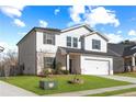 Two-story house with white siding, gray shutters, and a two-car garage at 4839 Dufour Dr, Lilburn, GA 30047