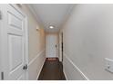 Bright hallway with dark hardwood floors and neutral walls at 5514 Park S Pl, Atlanta, GA 30349