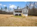 Gray house with white trim, two-car garage, and a deck at 23 Faith Ct, Douglasville, GA 30134