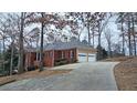 Two-story home with a three-car garage and long driveway at 1050 Wiley Bridge Rd, Woodstock, GA 30188