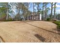 Expansive front lawn leading up to a stately two-story brick home with tall columns at 1579 Howell Highlands Dr, Stone Mountain, GA 30087