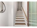 Bright staircase featuring wood treads, white risers, and a classic wooden handrail at 1590 Ridgebrook Downs, Mableton, GA 30126