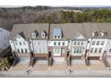 Aerial view of a row of townhouses with gray roofs and attached garages at 2134 Old Georgian Nw Ter, Atlanta, GA 30318