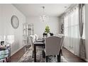 Formal dining room with hardwood floors, chandelier, and seating for six at 1508 Denver Way, Locust Grove, GA 30248