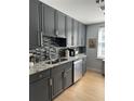 Modern kitchen with granite countertops, stainless steel appliances, and stylish tile backsplash at 195 14Th Ne St # 902, Atlanta, GA 30309