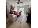 Bright living room with hardwood floors, modern furniture, and sliding glass doors to balcony at 195 14Th Ne St # 902, Atlanta, GA 30309