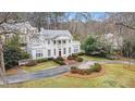 Elegant estate with a circular driveway, lush landscaping, and a grand facade at 7 W Andrews Nw Dr, Atlanta, GA 30305