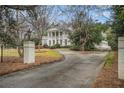 Long, paved driveway leading to a distinguished home with mature trees at 7 W Andrews Nw Dr, Atlanta, GA 30305