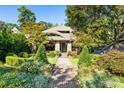 Inviting home featuring an arched entryway and professionally landscaped front yard with brick walkway at 2220 Edison Ave, Atlanta, GA 30305