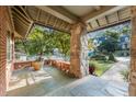 Relaxing porch featuring stone columns, slate flooring, brick walls and scenic neighborhood views at 2220 Edison Ave, Atlanta, GA 30305