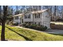 Gray house with brick accents and a two-car garage at 3001 Scott Rd, Marietta, GA 30066