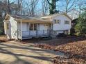 Attractive home with light grey siding, front porch with grey trim, and large front yard at 3667 Humphries Hill Rd, Austell, GA 30106