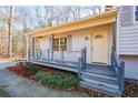 Inviting covered front porch with a unique gray-blue railing welcomes you to the home at 3667 Humphries Hill Rd, Austell, GA 30106