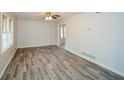 Spacious living room with hardwood floors, ceiling fan, and natural light at 3667 Humphries Hill Rd, Austell, GA 30106