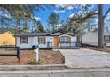 Newly renovated single story home with modern gray accents and wood shutters at 2918 Fields Dr, Lithonia, GA 30038