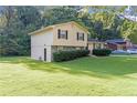 Side view of a charming house with a large backyard at 3589 Satellite Blvd, Ellenwood, GA 30294