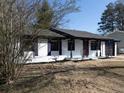 White brick ranch house with navy blue accents and a landscaped yard at 6030 Danbury Court, Morrow, GA 30260