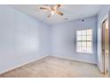 Bedroom featuring light blue walls, carpet flooring, a ceiling fan, and a window at 633 Herron Ct, Fairburn, GA 30213