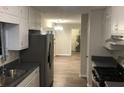 Eat-in kitchen with stainless steel appliances and laminate floors at 1079 Salisbury Trl, Riverdale, GA 30296