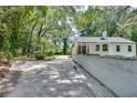 Long driveway leading to a charming white brick house with lush landscaping at 265 Whitaker Nw Cir, Atlanta, GA 30314