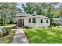 Charming white brick ranch house with a spacious front yard and mature trees at 265 Whitaker Nw Cir, Atlanta, GA 30314