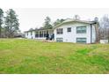 Charming white brick home with black accents, front porch, and spacious lawn at 218 Ward Rd, Ellenwood, GA 30294