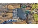 A rear aerial view showcasing a backyard with a play structure and mature trees at 6460 Boca Grande Blvd, Forest Park, GA 30297