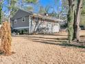 Charming single-Gathering home featuring neutral siding, mature trees, and landscaping at 6460 Boca Grande Blvd, Forest Park, GA 30297