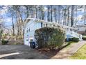 Side view of the house showcasing garage and landscaping at 4086 Pecan Nw Ct, Lilburn, GA 30047