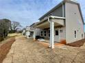 Newly constructed home with a backyard patio and new landscaping at 261 Dahlia Dr, Woodstock, GA 30188