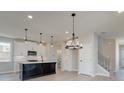 Modern kitchen with white cabinets, large island, and pendant lighting at 261 Dahlia Dr, Woodstock, GA 30188