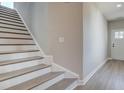 Modern staircase with wood and white risers in a new home at 261 Dahlia Dr, Woodstock, GA 30188