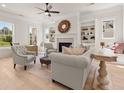 Bright living room featuring built-in shelves, fireplace, and comfortable seating at 5247 Flannery Chase Sw, Powder Springs, GA 30127