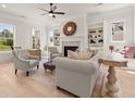 Living room features hardwood floors, fireplace, built-in shelving and large windows at 5247 Flannery Chase Sw, Powder Springs, GA 30127