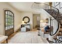 Grand foyer with a curved staircase, zebra print runner, stone floors, and designer decor at 2631 Habersham Nw Rd, Atlanta, GA 30305