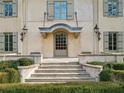 Elegant front entrance with stone steps, a covered porch, and manicured hedges, offering a welcoming facade at 2631 Habersham Nw Rd, Atlanta, GA 30305