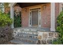 Stone steps leading to a covered porch and dark brown front door at 1325 Cameron Glen Dr, Marietta, GA 30062