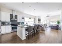 Open concept kitchen with white cabinets, granite island, and stainless steel appliances at 165 Mayson Ne Ave, Atlanta, GA 30307