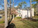 Beautiful two-story home with an exterior featuring a fenced yard and mature trees at 749 Scarlet Ne Dr, Kennesaw, GA 30144