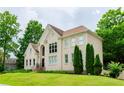 Tan brick house with a landscaped yard and lush greenery at 2120 Shaffer Rd, Cumming, GA 30041