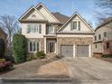 Two-story house with stone accents and a three-car garage at 2012 Mendenhall Cir, Atlanta, GA 30341