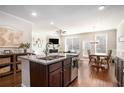 Bright, open kitchen with granite countertops and a breakfast bar overlooking the living area at 366 Cherryhill Ln, Woodstock, GA 30188