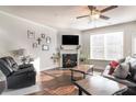 Cozy living room with fireplace, plush seating, and plenty of natural light at 366 Cherryhill Ln, Woodstock, GA 30188