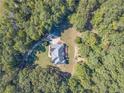 House nestled in a large wooded lot, offering privacy at 946 Gaithers Rd, Mansfield, GA 30055